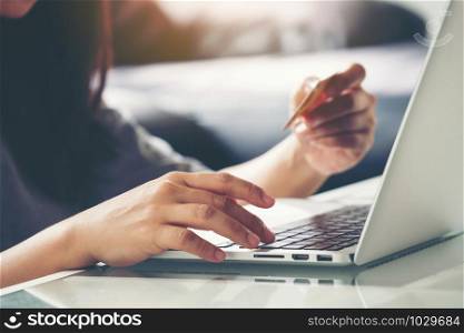 Women use credit card to shopping online at her home