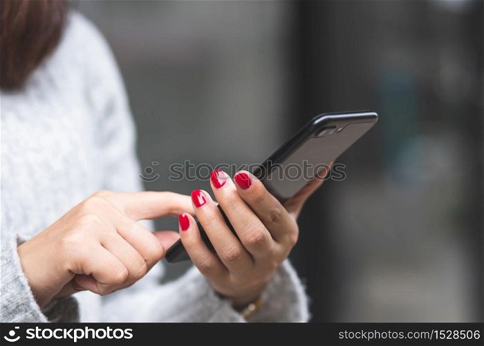Women using mobile phones to pay for goods at the mall
