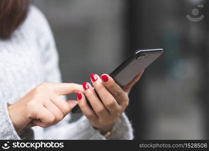 Women using mobile phones to pay for goods at the mall