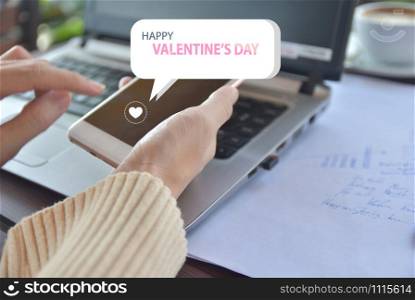 Women using mobile smart phone message Happy Valentine&rsquo;s Day concept,Love message
