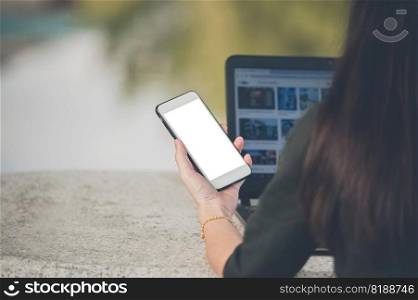 Women using mobile smartphone sitting on table outdoor online internet