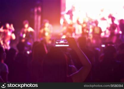 Women using smartphone take a photo in concert,Happy new year party