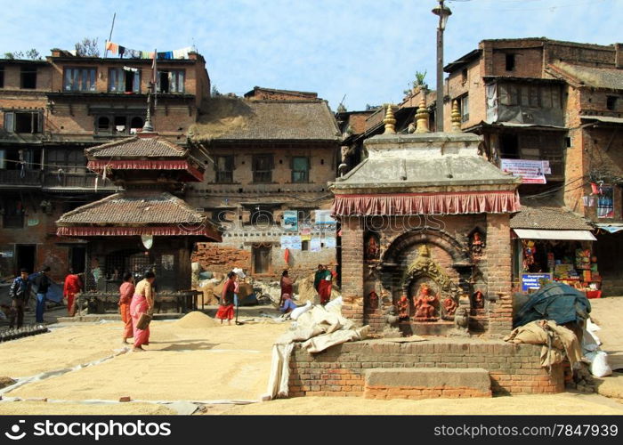 Women walk on the grain in ssquare in Bhaktapur, Nepal