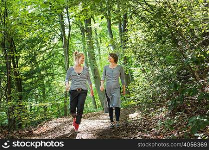 Women walking together in forest