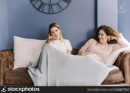women watching tv sofa