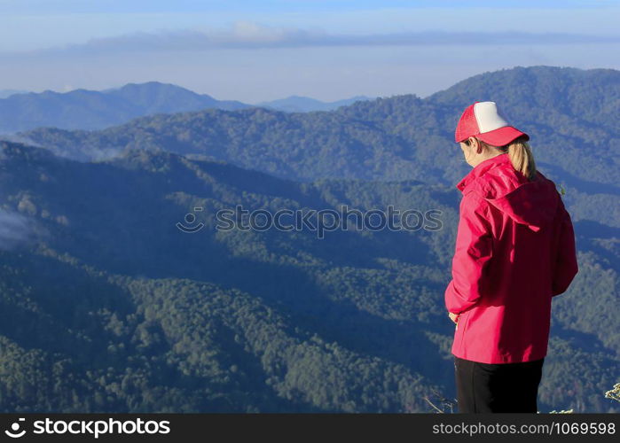 Women wear red shirts on the mountain.