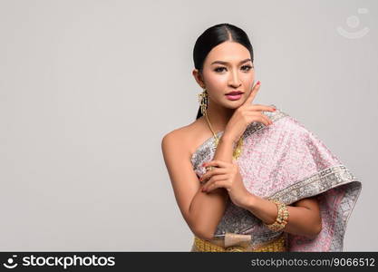 Women wearing Thai clothes and hands touching their faces