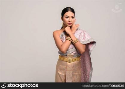 Women wearing Thai clothes and hands touching their faces
