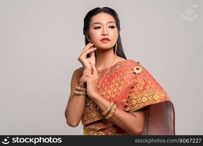 Women wearing Thai clothes and hands touching their faces