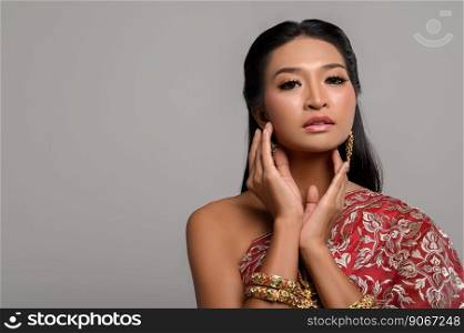 Women wearing Thai clothes and hands touching their faces