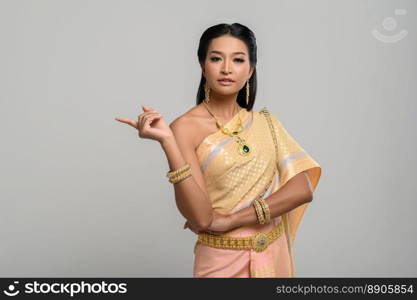 Women wearing Thai costumes that are symbolic, pointing fingers