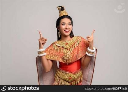 Women wearing Thai costumes that are symbolic, pointing fingers