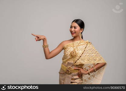 Women wearing Thai dress, hand symbol pointing to the right-hand side