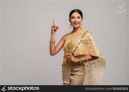 Women wearing Thai dress, hand symbol pointing to top