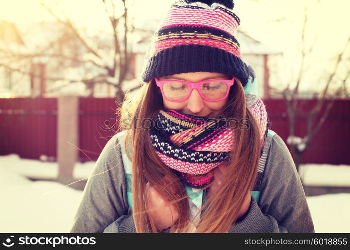 Women winter portrait. Fashion portrait of funny young hipster woman with hat and scarf. Outdoors, lifestyle