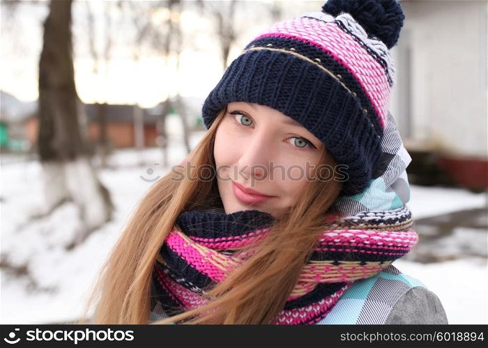 Women winter portrait. Fashion portrait of funny young hipster woman with hat and scarf. Outdoors, lifestyle