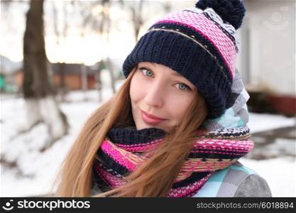 Women winter portrait. Fashion portrait of funny young hipster woman with hat and scarf. Outdoors, lifestyle