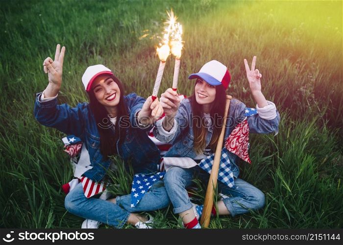 women with fireworks hands smiling