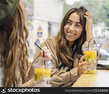 women with fresh drinks cafe