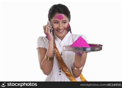 WOMEN with holi colour talking on a mobile phone
