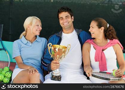 Women with Man Holding Tennis Trophy