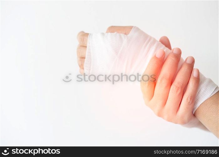 Women with painful wrist due to overuse or sport accidental on white background, Hand of girl strapping with bandage and Cure injuries by doctor