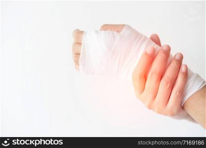 Women with painful wrist due to overuse or sport accidental on white background, Hand of girl strapping with bandage and Cure injuries by doctor