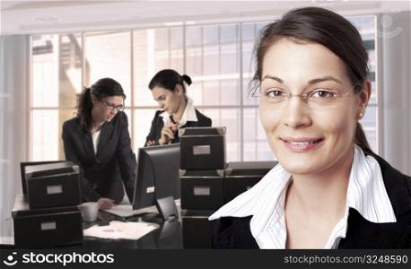 Women work in brightly lit office. Daylight, indoor, office.