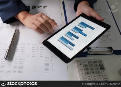 Women working in office. financial analysis with charts on pad for business, accounting, insurance or finance concept