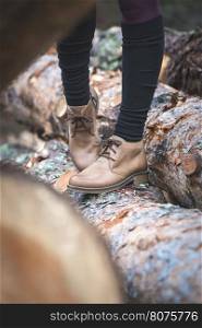 Womens leather casual shoes on wood in the forest.