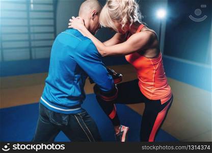 Womens self defense workout with personal instructor, fighting training in gym, martial art