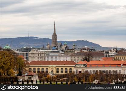 Wonderful cityscape with view of Unteres Belvedere complex and other historic buildings on a background of grey cloudy sky on autumn day in Vienna, Austria.. Cityscape with view of Unteres Belvedere and other historic buildings in Vienna.