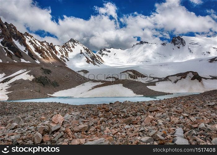 Wonderful mountain landscape with lake, clouds, peaks . Picturesque view near Adygine lake in Kyrgyz Alatoo mountains, Tian-Shan, Kyrgyzstan.. Wonderful mountain landscape with lake, clouds, peaks . Picturesque view near Adygine lake.