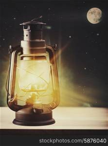 Wonderful night and vintage magic lantern on the window, abstract holidays background