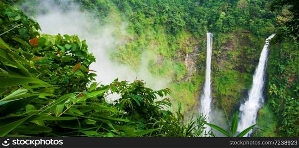Wonderful Tad Fane waterfall in the misty, picturesque twin waterfall in rainy season, tourist attractions in South Laos.