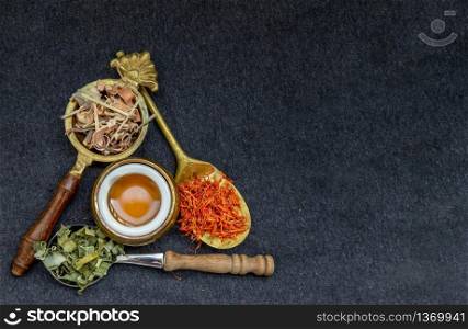 Wonderful Thai herbal tea with Dried lemongrass herb and pandanus and safflower on spoons with honey. Organic herbal, Selective focus, Copy space.