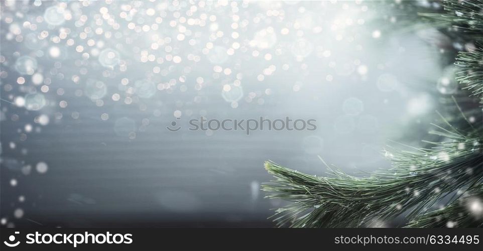 Wonderful winter background with fir branches, snow and bokeh lighting. Winter holidays and Christmas concept