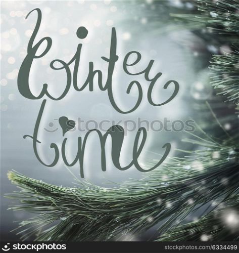 Wonderful winter background with fir branches, snow and Winter time lettering. Winter holidays concept