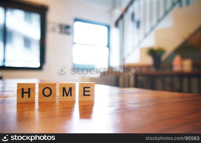 Wood block HOME word on wooden table for background. copy Space.
