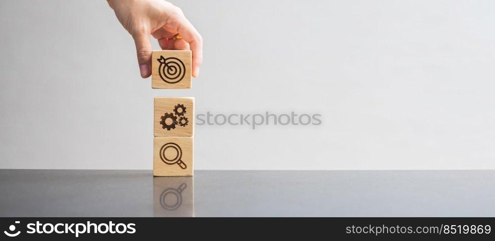 wood block with business goal, strategy, target, mission, action, objective, teamwork, brainstorm and idea concept