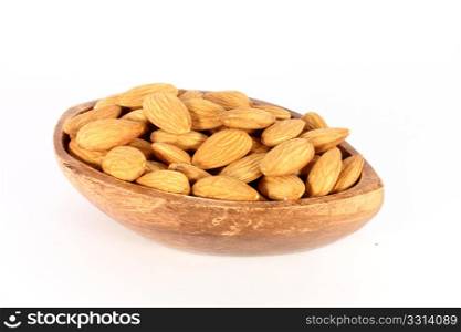 Wood bowl full of almonds, isolated on white