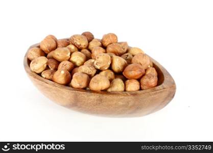 Wood bowl full of hazelnuts, isolated on white