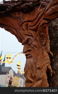 Wood carving of a mans face at a Christmas Market, Cologne, Germany