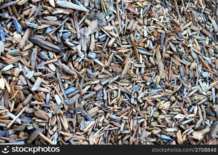 Wood chippings on the gound in a park, close up background.