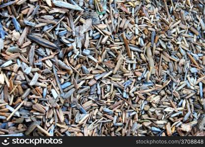 Wood chippings on the gound in a park, close up background.
