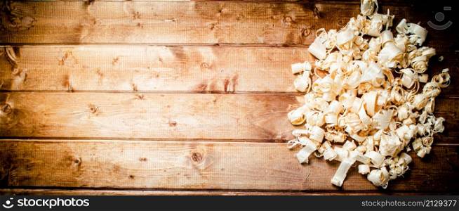 Wood chips on the table. On a wooden background. High quality photo. Wood chips on the table.