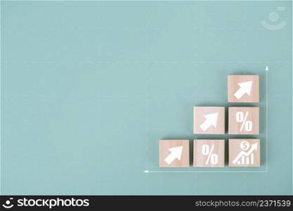 Wood cube block stacking as step stair with arrow up and percent symbol icon , concept of financial for business growth success process