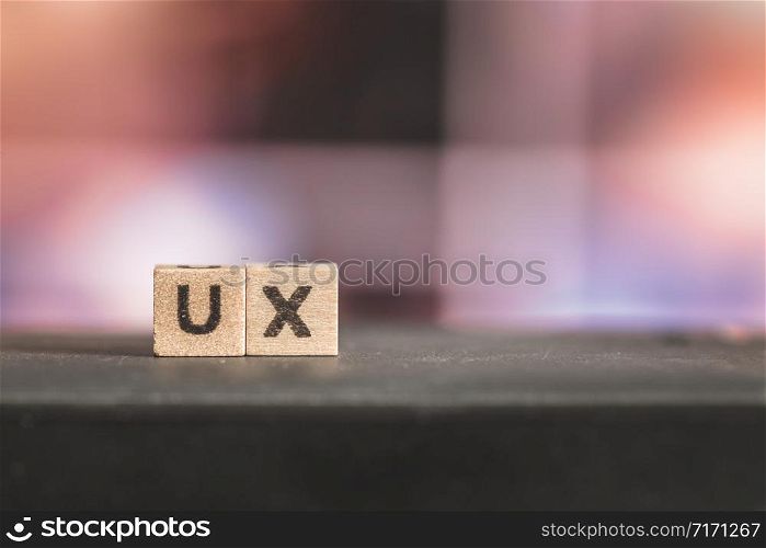 Wood cubes with the word ?ux?, close up picture with copy space