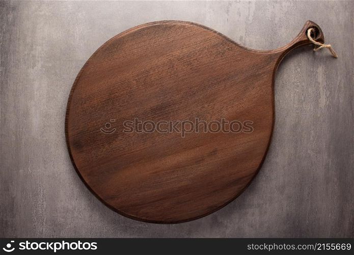 Wood cutting board at stone background top table. Wooden pizza board