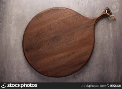 Wood cutting board at stone background top table. Wooden pizza board